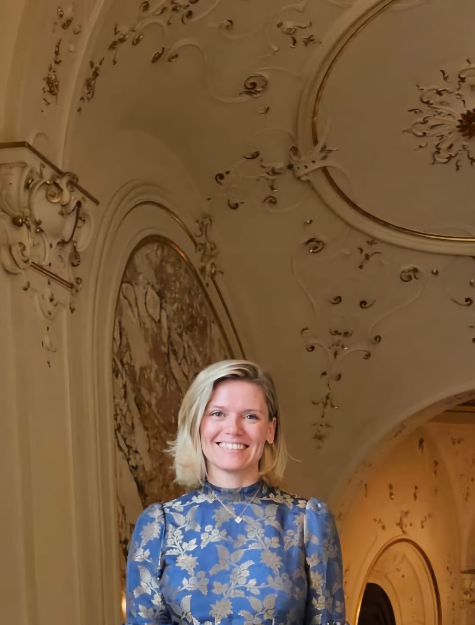 Jennifer J. Martin smiling in a blue floral dress